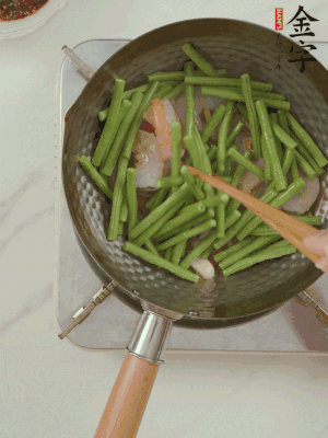 下掰好的缸豆段翻炒，略燜煮。